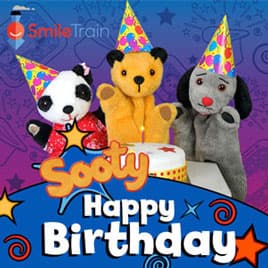 Sooty, Sweep and Sue around birthday cake 'Sooty Happy Birthday' birthday ecard